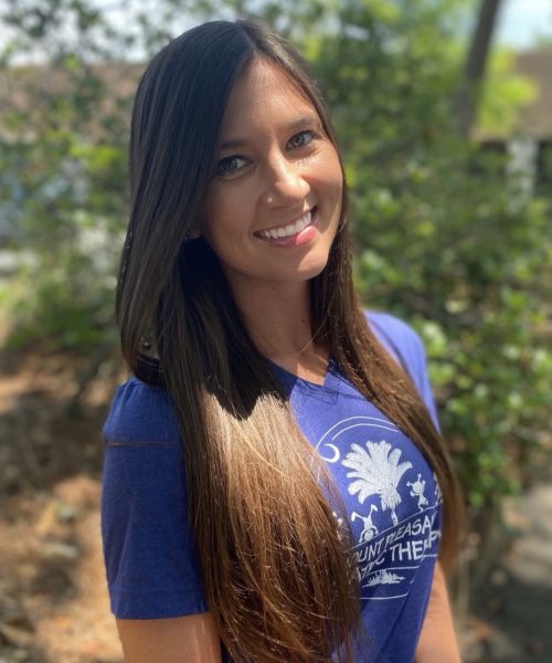 Smiling woman in a blue T-shirt.
