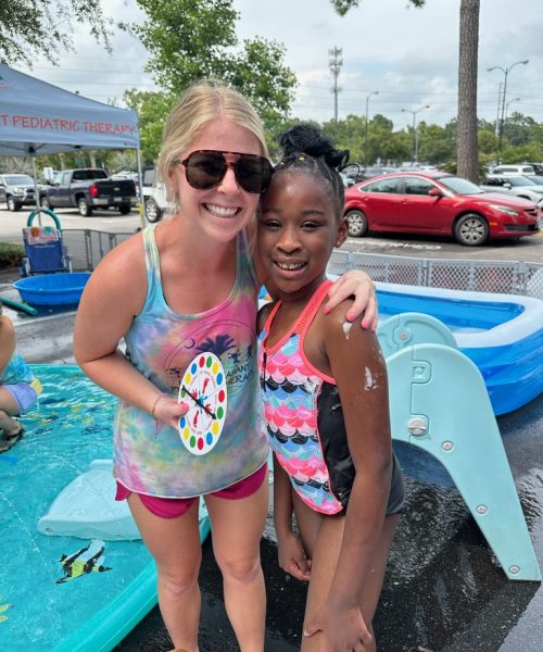Two people smiling at water park.