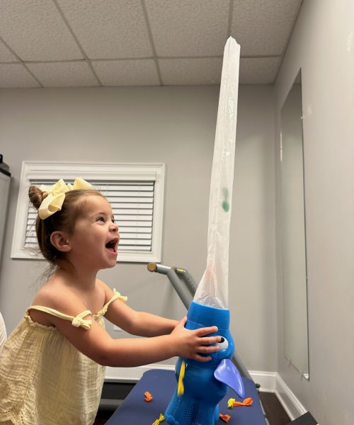 Child amazed by toy elephant air stream.