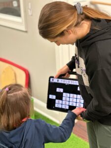 Child and adult using a tablet together.
